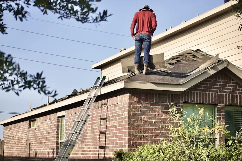 Professional roofer working on a residential roof in North Amityville